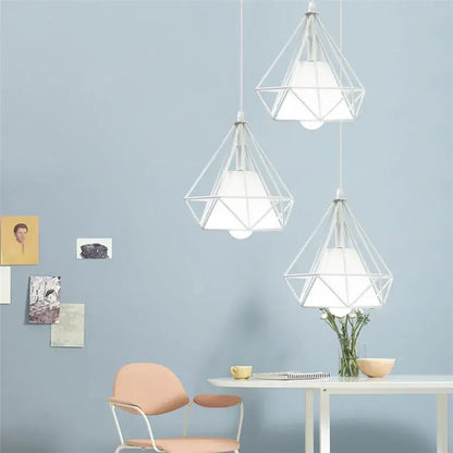 Three white geometric diamond pendant lights trio with wireframe design hanging for modern kitchen lighting