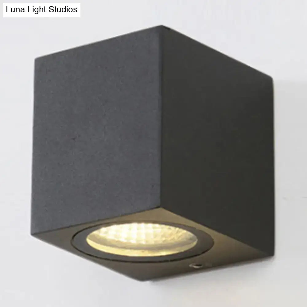 Black cube shaped modern led outdoor wall mount with warm circular led bulb for geometric patio lighting