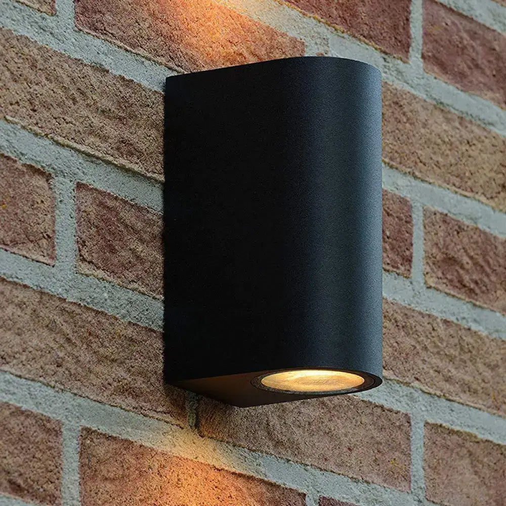 Modern black geometric led outdoor wall mount with matte finish and warm-toned led outdoor wall light bulb