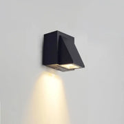 Modern black geometric led outdoor wall mount with angular design and warm focused illumination for patio use
