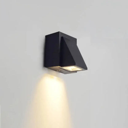 Modern black geometric led outdoor wall mount with angular design and warm focused illumination for patio use