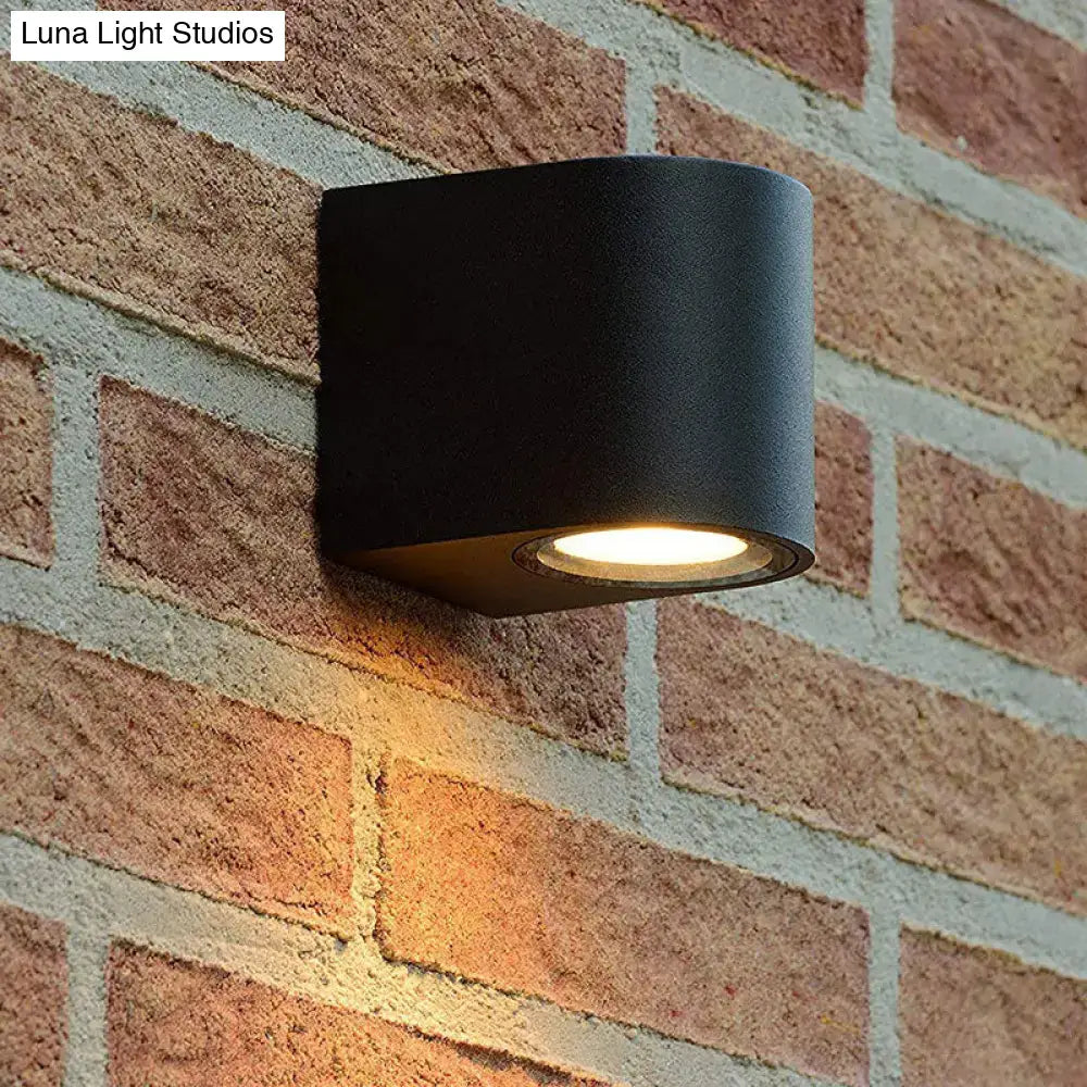Modern black geometric led outdoor wall mount with matte finish and warm focused illumination for patio lighting