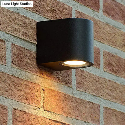 Modern black geometric led outdoor wall mount with matte finish and warm focused illumination for patio lighting