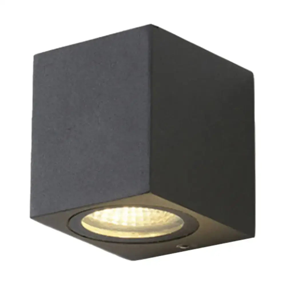 Modern black geometric led outdoor wall mount featuring a recessed led bulb with warm white illumination