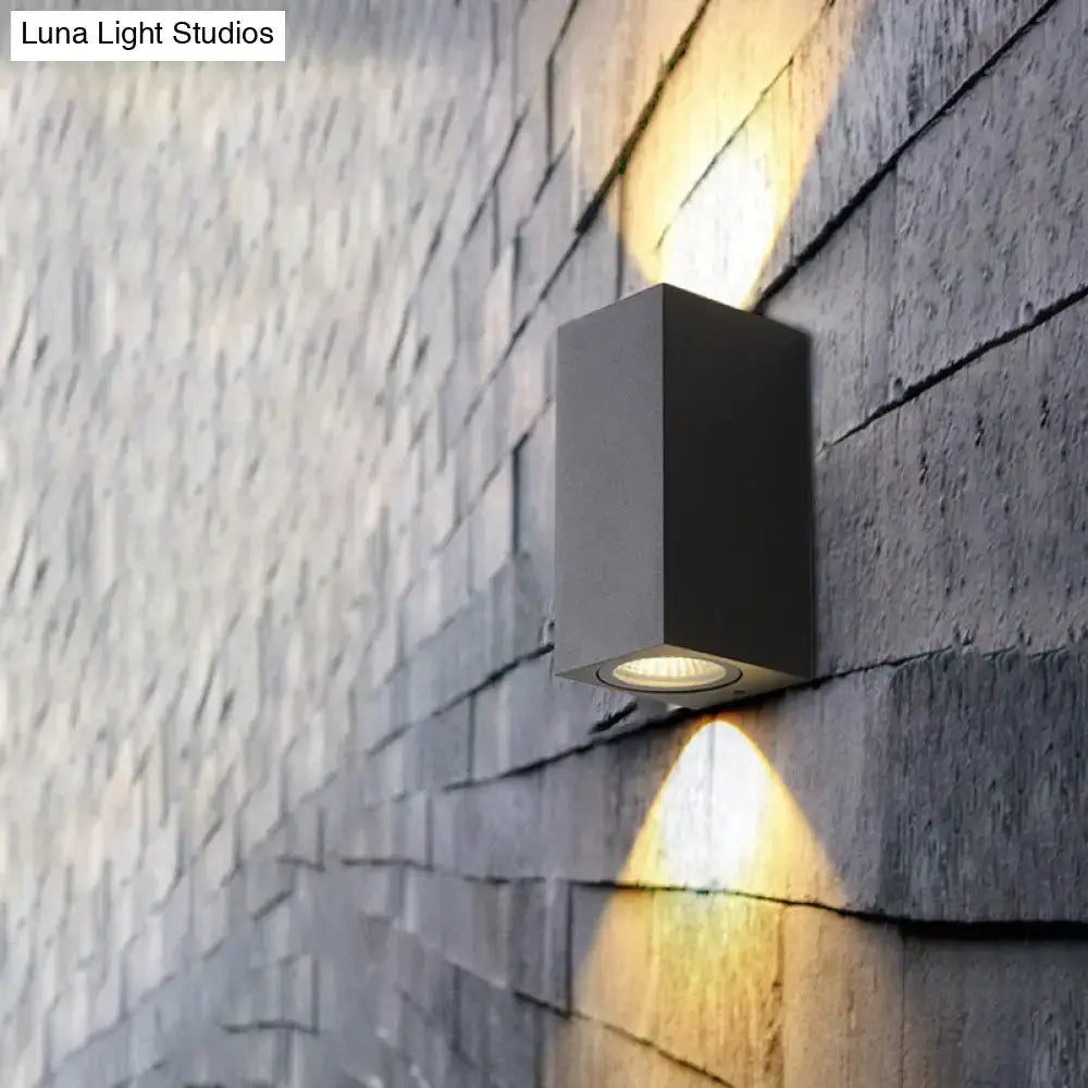 Modern black geometric led outdoor wall mount featuring a matte black rectangular outdoor wall sconce with warm focused lighting