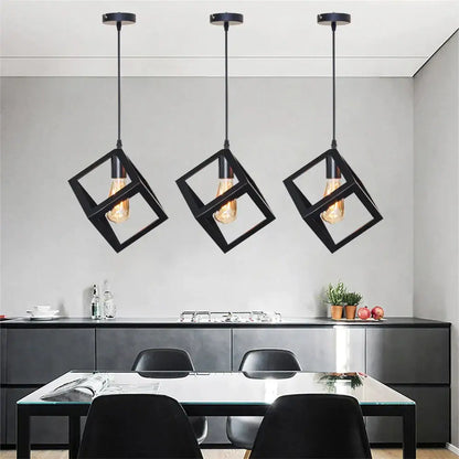 Modern black geometric pendant light with three exposed filament bulbs hangs above a kitchen island decorbites black geometric