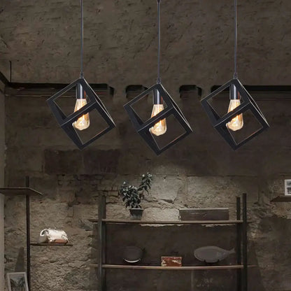 Three black geometric pendant lights with industrial cube frames and exposed filament bulbs for kitchen island decorbites black geometric