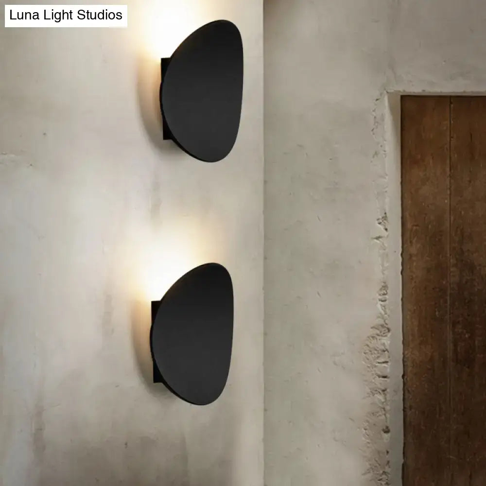 Black geometric wall lighting fixture with modern oval design and matte finish for bedroom wall lighting