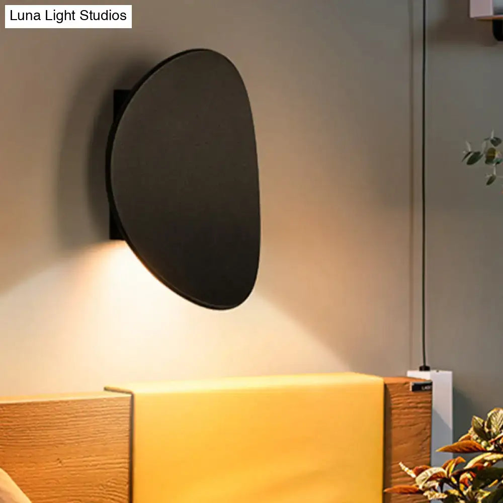 Modern black geometric wall lighting fixture with sleek minimalist oval design ideal for bedroom wall lighting