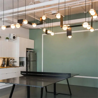 Modern black glass ball geometric chandelier kitchen pendant light with sleek metal surface and angular legs decorbites glass ball