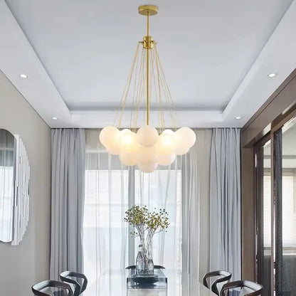 Gold-toned ball led chandelier with frosted glass globe shades suspended by thin cords for modern living room decorbites glass ball