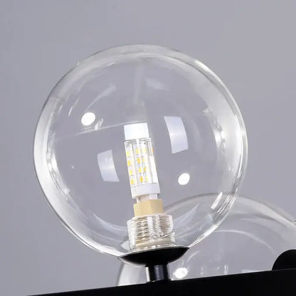 Clear glass bubble chandelier globe with modern led bulb featuring visible yellow leds and metallic base for dining room