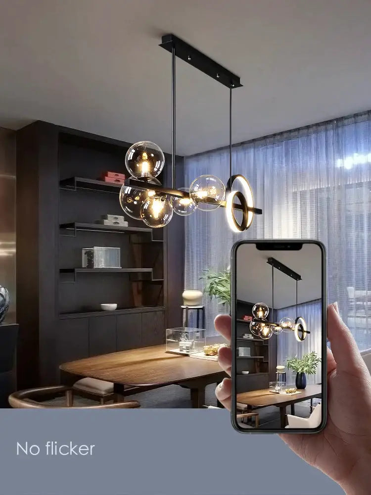 Modern black glass bubble chandelier with sleek metal frame and warm glowing bulbs for dining room ring light