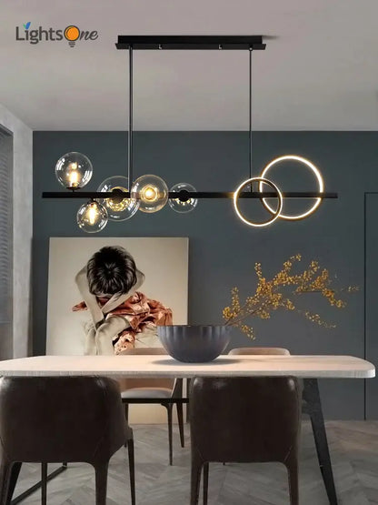 Modern black glass bubble chandelier with illuminated spheres and glowing rings for dining room lighting
