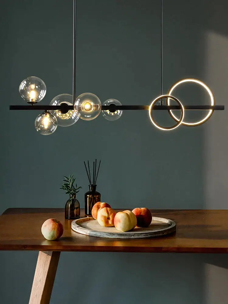Modern black metal glass bubble chandelier with clear glass spheres and glowing rings for dining room lighting