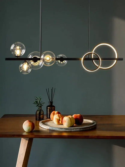 Modern black metal glass bubble chandelier with clear glass spheres and glowing rings for dining room lighting