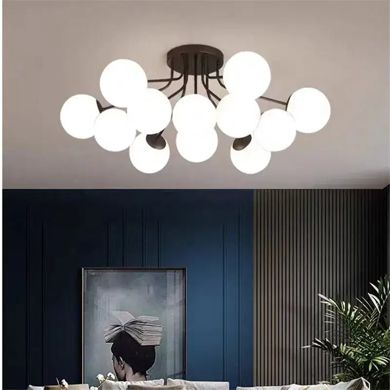 Modern black ceiling light with white glass bubble led globes clustered on a dark bronze metal frame by decorbites
