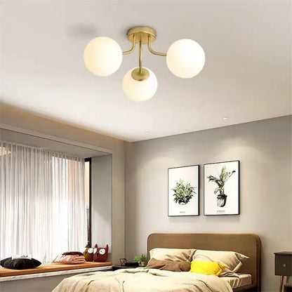 Gold-toned ceiling light with three frosted white spherical glass shades decorbites glass bubble led fixture
