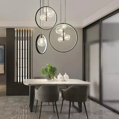Modern black glass bubble led chandelier with circular pendant lights and clear glass orbs above dining table decorbites glass bubble