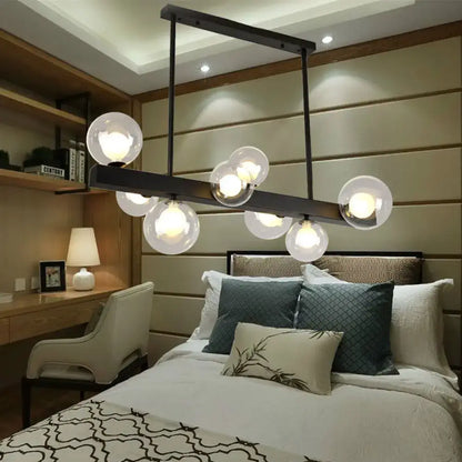 Modern black metal chandelier with eight spherical glass globe lights for dining room and kitchen island lighting