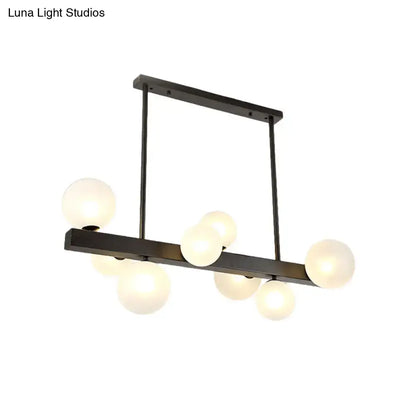 Modern black metal chandelier with frosted glass globe bulbs for dining room and kitchen island lighting by DecorBites
