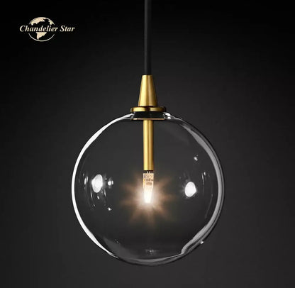 Modern black glass globe pendant light with clear glass globe and gold-toned metal fixture for dining room decorbites glass globe