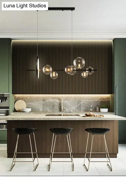 Modern black metal chandelier with clear glass globe bulbs for dining table featuring exposed bulb base light type