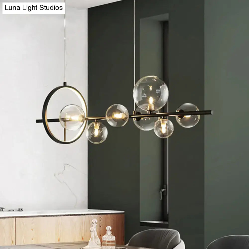 Modern black metal chandelier with clear glass globe bulbs and circular accent ring for dining table light type