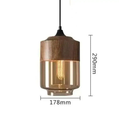 Modern black glass pendant light with warm amber glass and dark wood accents featuring exposed filament bulb for dining room decorbites black glass