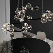 Modern black glass ring pendant light featuring clear glass globe bulbs for elegant dining room decorbites black glass chandelier