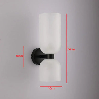 Modern black wall lamp with two frosted white glass shades featuring smoked glass for bedroom use