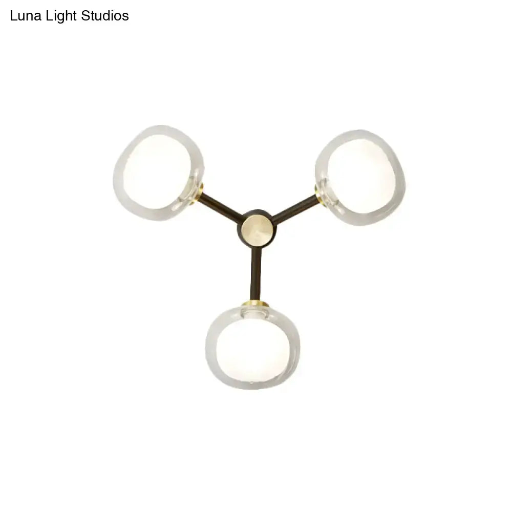 Modern wall lamp with dark metal arms and frosted glass shade designed for bedroom lighting