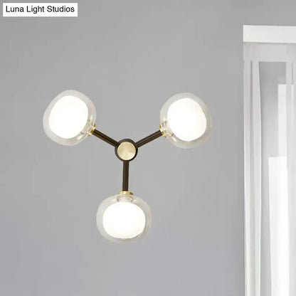 Modern black and gold three-light wall lamp with clear glass shade and matte black metal frame for bedroom lighting