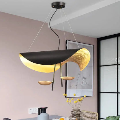 Modern black and gold abstract pendant lamp with sculptural flowing design for dining room decorbites lederam manta