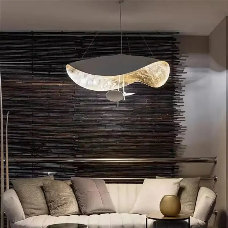 A modern black and gold decorbites lederam manta pendant light with a sleek metallic finish for dining room decor