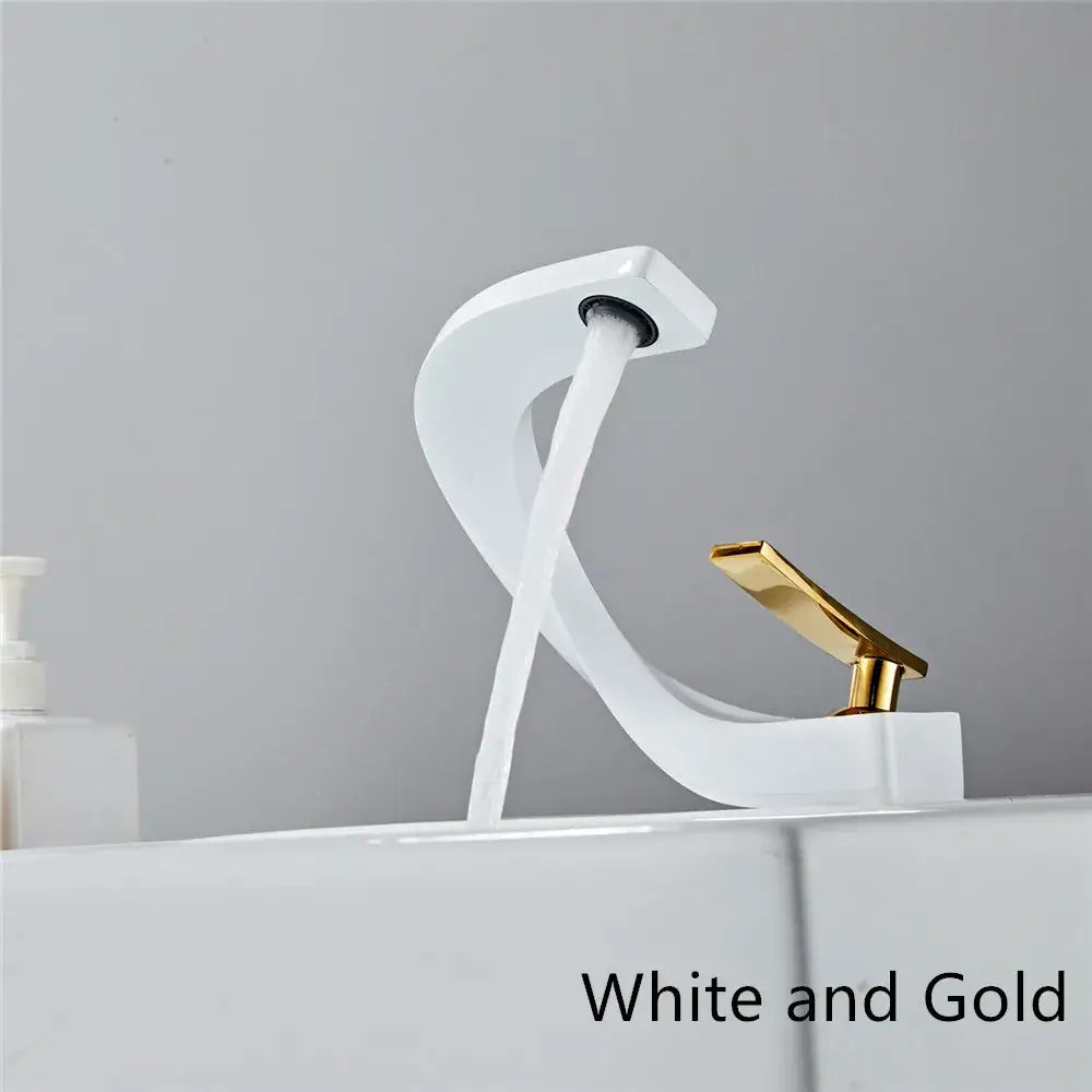 Modern black and gold basin faucet with a white and gold sleek curved waterfall design decorbites black basin faucet