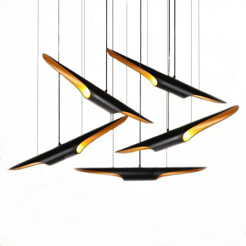 Modern black and gold blade pendant light with sleek angular design for dining room decorbites coltrane pendant light