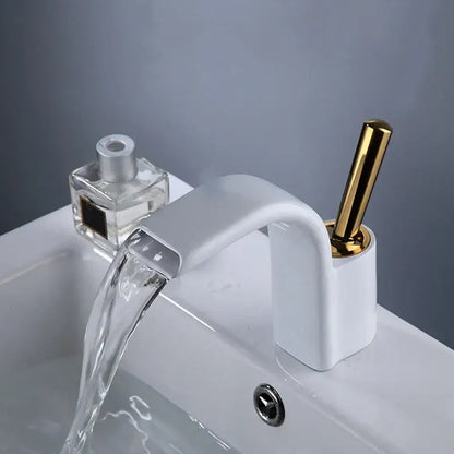 Modern white ceramic basin faucet with polished gold decorbites black brass handle and sleek curved spout for bathroom sink