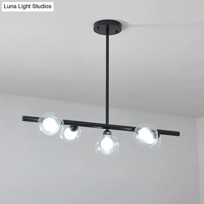 Modern black ceiling light with three bubble clear glass globes and sleek horizontal bar for clear glass island use