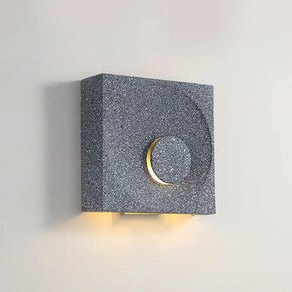 Modern gray speckled stone wall light with gold-toned circular accent ideal as bedroom wall light type moon sconce