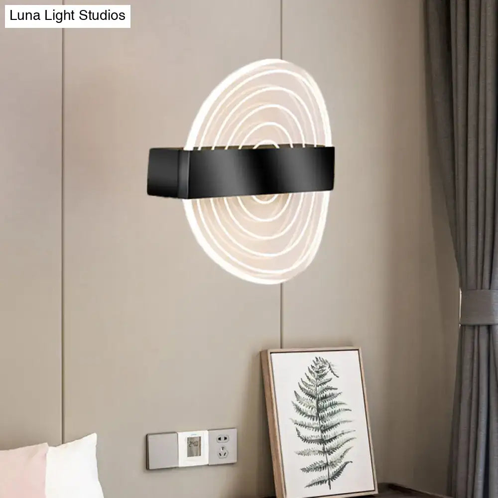 Modern black and gold wall lamp with concentric led rings emitting soft white glow, an ideal choice for living room