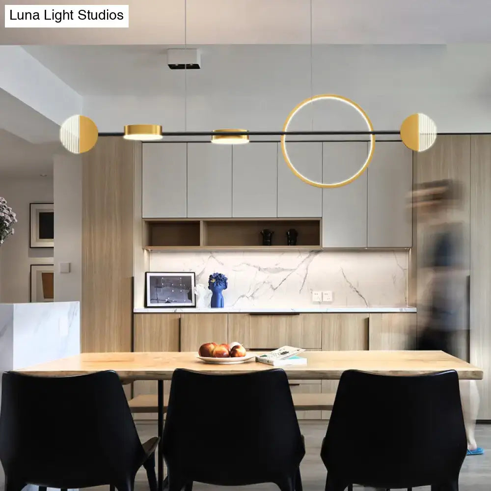 DecorBites™ contemporary gold LED pendant light with circle metal island design above wooden dining table