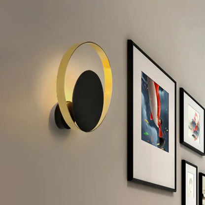 Modern black and gold circular led wall sconce with sleek minimalist design ideal as a bedroom wall lamp