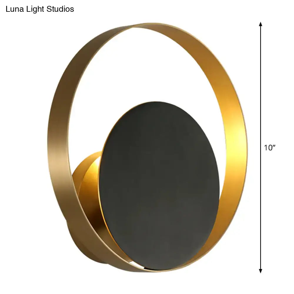 Modern black and gold circular led wall sconce with a matte black central disc wall lamp for bedroom use