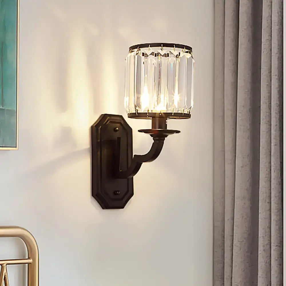 Antique bronze wall sconce with a cylindrical clear crystal shade in black gold for bedroom fixture height