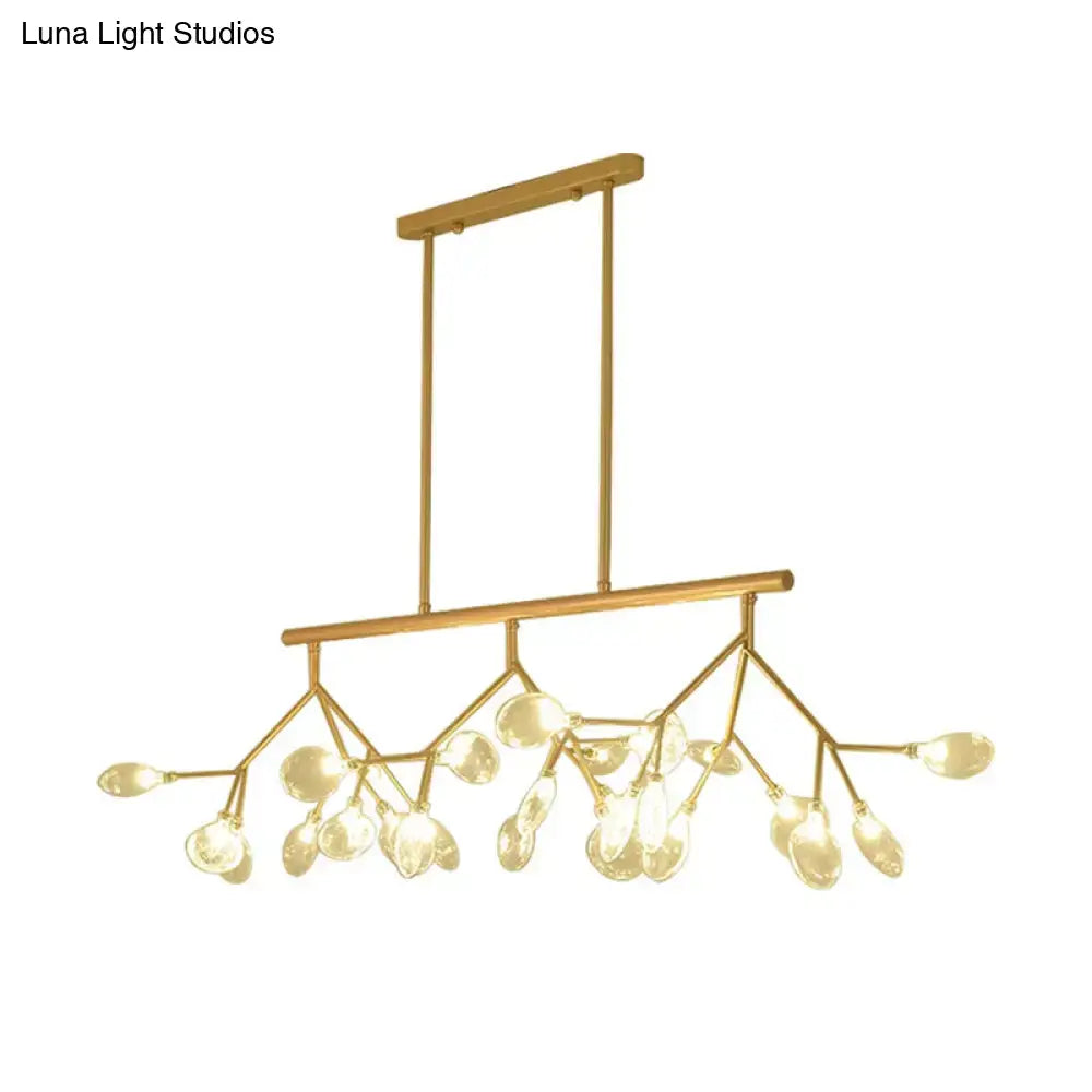 Modern black and gold chandelier with gold-toned branches and clear glass teardrop shades for dining room lighting