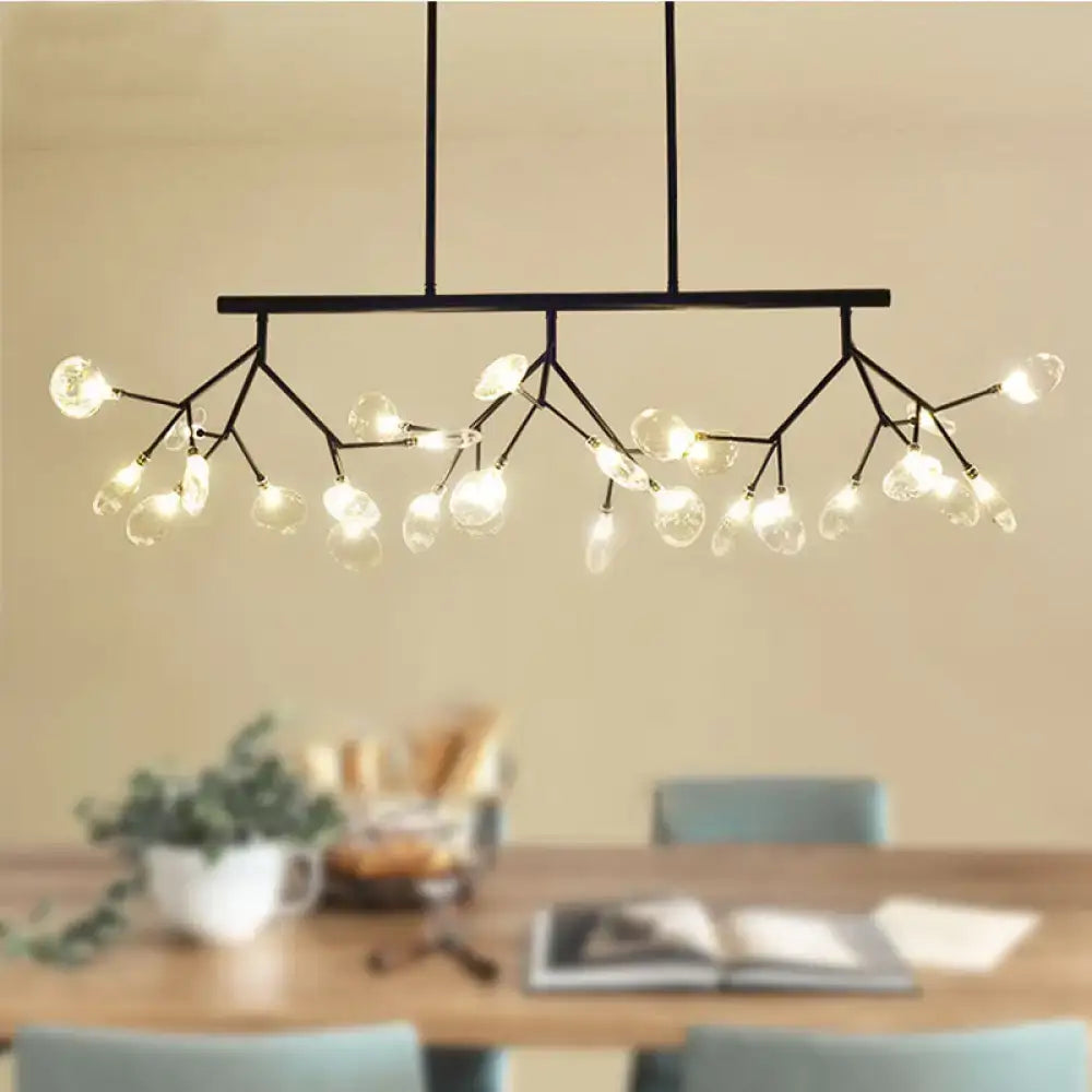 Modern black and gold chandelier with gold-toned arms and clear glass frosted globes for dining room lighting