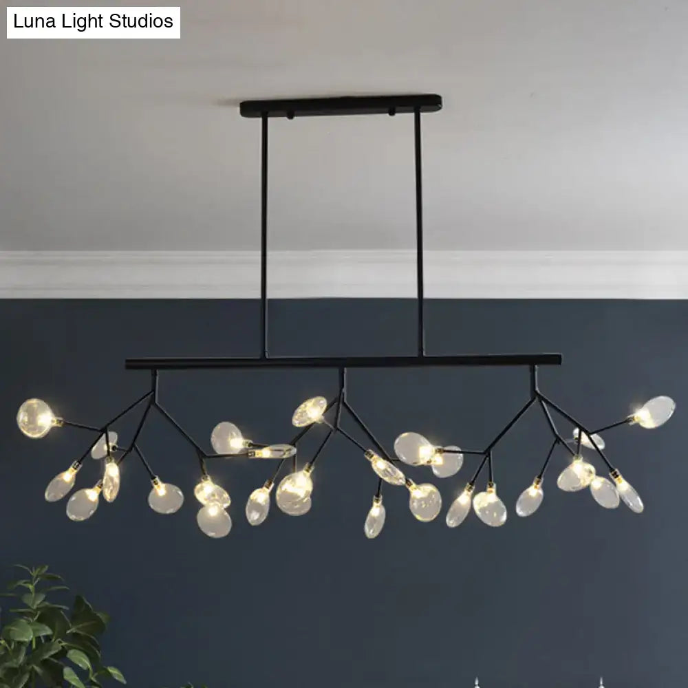 Modern black metal chandelier with branching arms holding clear glass teardrop bulbs for dining room lighting