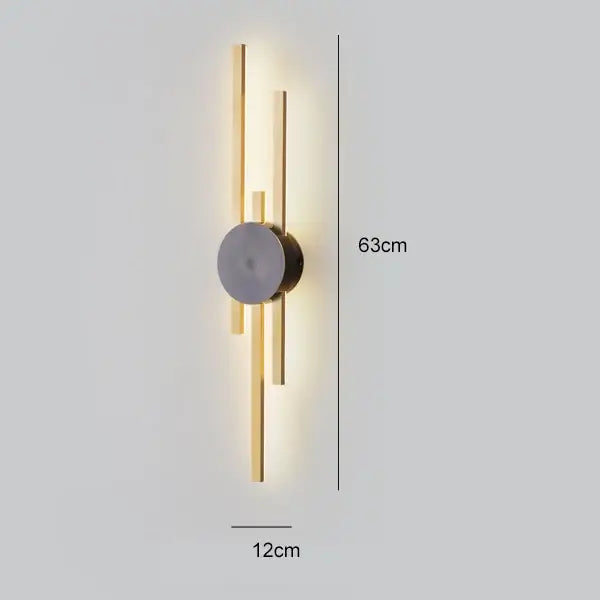 Modern black and gold copper wall light with circular center and vertical bars emitting warm light for bedroom decorbites copper wall