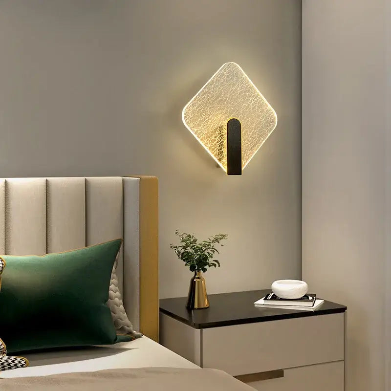Modern black led wall lamp with diamond-shaped textured glass panel and sleek metal base for bedroom lighting